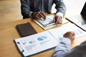 Business advisory meeting to discuss analysis of business growth charts and financial data.